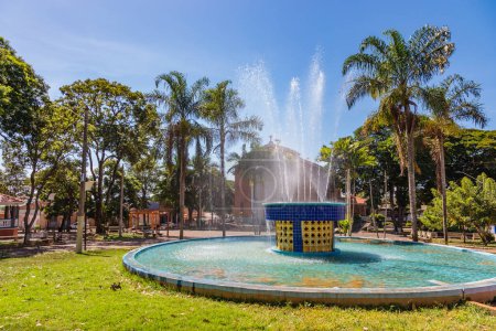 Photo for Serrana, So Paulo, Brazil - April 24, 2022: Water fountain and Mother Church in the central square of Serrana. - Royalty Free Image