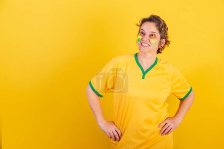 Photo for Adult adult woman, brazil soccer fan, hands on hips, smiling. - Royalty Free Image