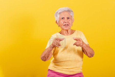 Photo for Old lady pointing at camera, index finger, choosing you. - Royalty Free Image