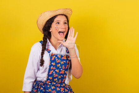 Girl wearing typical clothes for Festa Junina. screaming promotion, screaming sale. For the Festival do Arraia