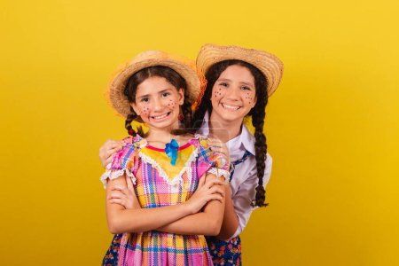 Photo for Sisters and friends, wearing typical clothes of the Festa Junina. Hugging, smiling. united, together. Friendship. - Royalty Free Image