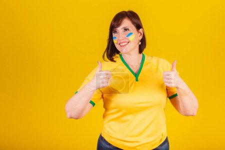 Photo for Red-haired woman, Brazilian soccer fan. like sign, thumb up. - Royalty Free Image