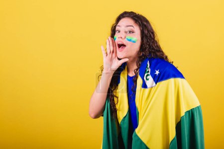 Photo for Woman soccer fan, fan of brazil, world cup, screaming goal, screaming offer, promotion, photo for advertisement. - Royalty Free Image