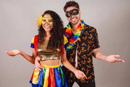 Photo for Brazilian couple, with carnival clothes. With open arms, welcome. - Royalty Free Image