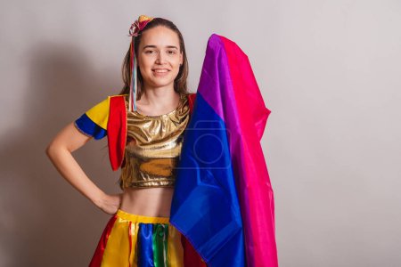 Photo for Beautiful Caucasian Brazilian woman wearing frevo carnival clothes with frevo parasol. with bisexual flag. - Royalty Free Image