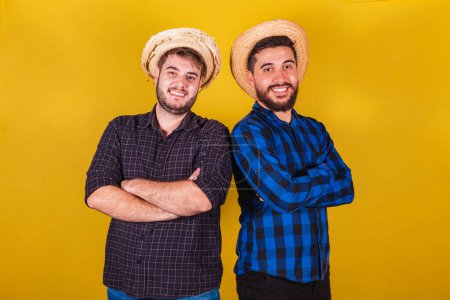Photo for Two friends wearing typical clothes for the Festa Junina. Feast of Arrai de So Joo. with arms crossed smiling - Royalty Free Image