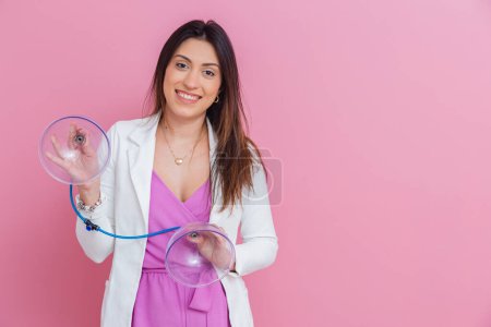 Photo for Professional beautician holding suction cups of pump up procedure, procedure for butt, beautiful ass. - Royalty Free Image