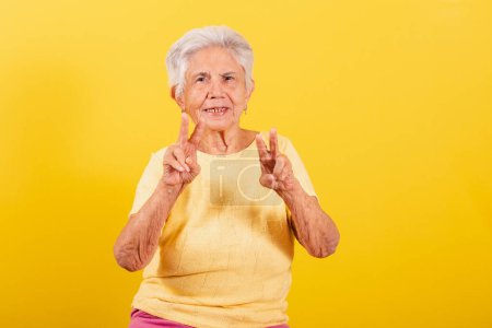Photo for Old lady, symbol of peace and love with fingers, cool. happy, joyful, victory. - Royalty Free Image