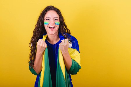 Photo for Soccer fan woman, brazil fan, world cup, holding flag and cheering - Royalty Free Image