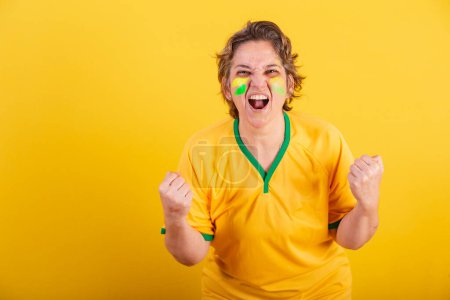 Photo for Adult adult woman, soccer fan from brazil, cheering and screaming goal. - Royalty Free Image
