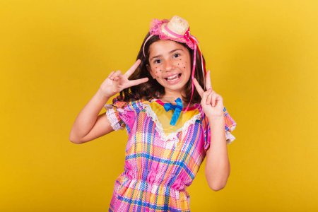 Photo for Brazilian, caucasian child, festa junina clothes, peace and love sign, pose for photo, joyful, selfie. May, June and July festivities, festa junina celebrations - Royalty Free Image