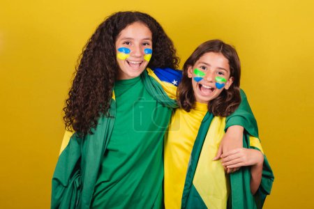 Photo for Friends cheering from Brazil, soccer fans hugging, smiling and cheering for a soccer game. World Cup. Olympics. - Royalty Free Image
