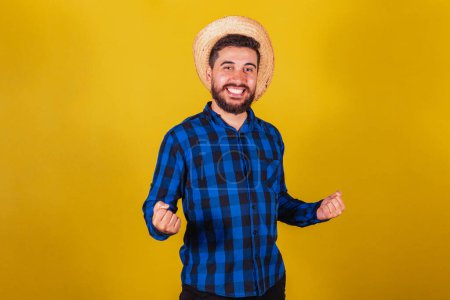 Photo for Man wearing typical clothes for Festa Junina. Celebrating, supporter, victory - Royalty Free Image
