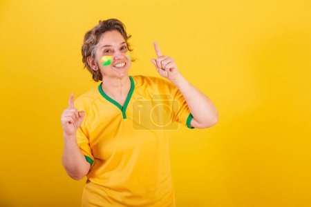 Photo for Adult adult woman, brazil soccer fan, dancing, partying, fun. - Royalty Free Image