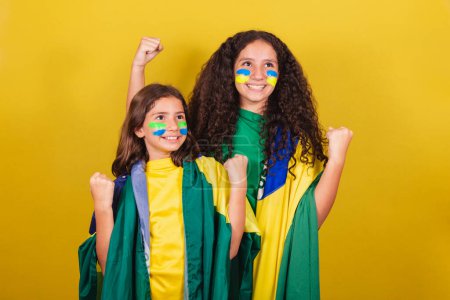 Photo for Sisters and friends supporters of Brazil, soccer fans, screaming yes! partying, cheering, wishing celebrating. World Cup. Olympics. - Royalty Free Image