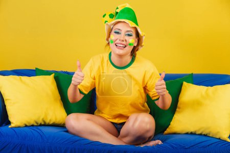 Photo for Caucasian woman, redhead, Brazilian soccer fan, Brazilian, No couch like sign with hand - Royalty Free Image