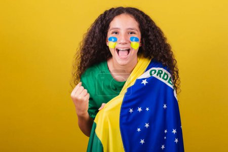 Photo for Brazilian, Caucasian girl, soccer fan, smiling, screaming yes, celebrating, partying, celebrating. - Royalty Free Image
