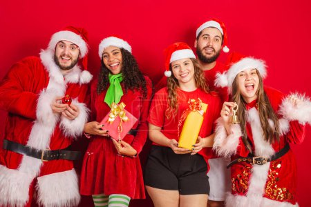 Photo for Brazilian friends, with christmas clothes, santa claus. at christmas party, with gifts. - Royalty Free Image
