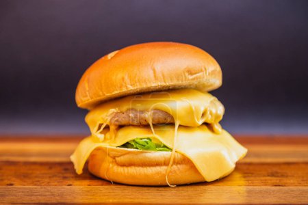 Photo for Delicious chicken sausage burger with mozzarella cheese. on wooden board. - Royalty Free Image