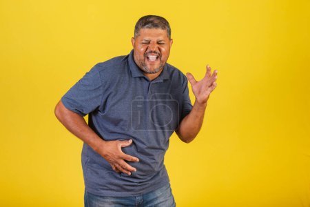Photo for Brazilian black man, adult with stomachache. cramps. - Royalty Free Image