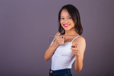 Photo for Young adult woman from northeastern brazil. Pointing at camera, choosing you, you, choose. - Royalty Free Image