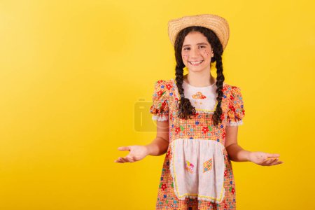 Photo for Girl wearing traditional orange clothes for festa junina. With open arms, welcome, welcoming. - Royalty Free Image