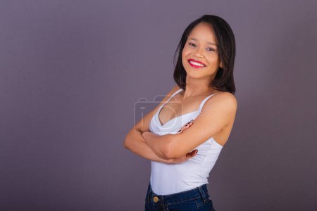 Photo for Young adult woman from northeastern brazil. crossed arms. confident and smiling. - Royalty Free Image