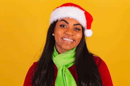 Photo for Beautiful black Brazilian woman, dressed in Christmas clothes, Santa Claus, smiling close-up. - Royalty Free Image