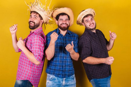 Photo for Three friends wearing typical clothes for the Festa Junina. Dancing, partying. - Royalty Free Image