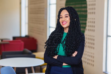 Photo for Young black woman, brazilian, entrepreneur, business woman, arms crossed smiling in office. - Royalty Free Image