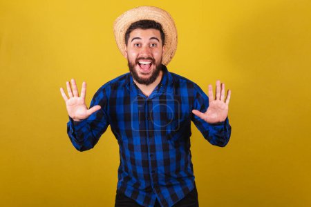 Photo for Man wearing typical clothes for Festa Junina. Expression of surprise, wow, amazing - Royalty Free Image