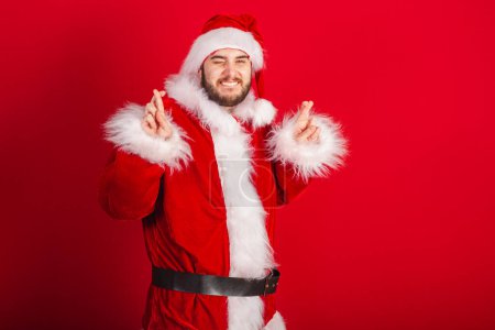 Photo for Caucasian, Brazilian man dressed in Christmas outfit, Santa Claus. lucky, cheering, wanting a lot. - Royalty Free Image