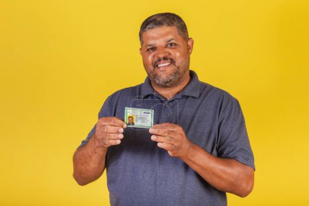 Photo for Brazilian black man, adult with identity card, RG. Brazilian document. - Royalty Free Image