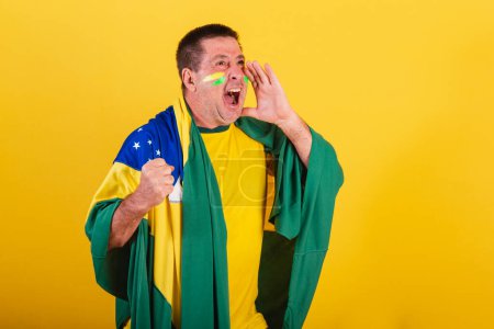 Photo for Adult man, soccer fan from brazil, using flag, shouting promotion. advertising photo. - Royalty Free Image