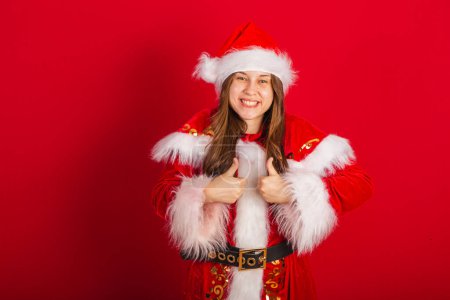 Photo for Caucasian, Brazilian woman in Christmas clothes, Santa Claus. Like sign with fingers. - Royalty Free Image