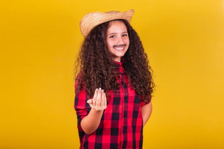 Photo for Caucasian girl, dressed as a boy, party clothes, calling with her hands, come, here. Festivals in May, June and July. - Royalty Free Image
