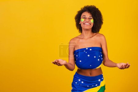 Photo for Young black woman brazilian soccer fan. open arms - Royalty Free Image