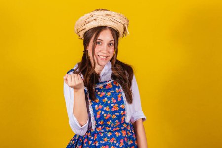 Photo for Woman wearing typical clothes for the Festa Junina. calling with your hands. inviting, come here - Royalty Free Image