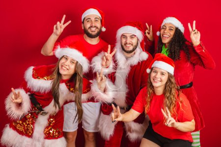 Photo for Brazilian friends, with christmas clothes, santa claus. celebrating christmas. - Royalty Free Image