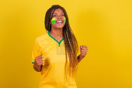 Photo for Black woman young brazilian soccer fan. screaming yes, victory. soccer brazil. - Royalty Free Image