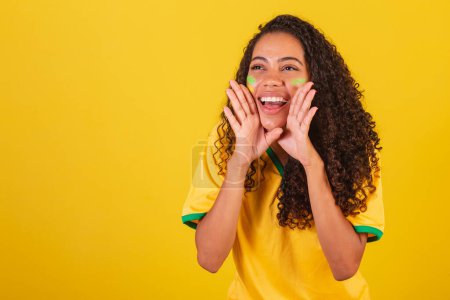 Photo for Young black Brazilian woman, soccer fan. screaming promotion - Royalty Free Image