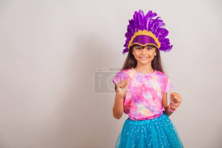 Photo for Beautiful Brazilian girl, child, dressed for carnival in Brazil. dancing, partying. - Royalty Free Image