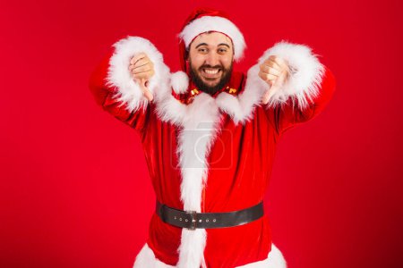 Photo for Brazilian man, dressed in santa claus clothes, dislike sign - Royalty Free Image