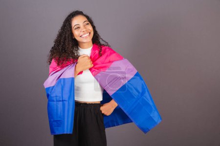 Photo for Young black Brazilian woman, bisexual flag as cover, Bisexual woman, LGBT, LGBTQ - Royalty Free Image