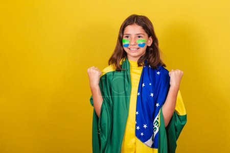 Photo for Brazilian, Caucasian, soccer fan, arms raised, celebrating, confident and joyful. World Cup. Olympics. - Royalty Free Image
