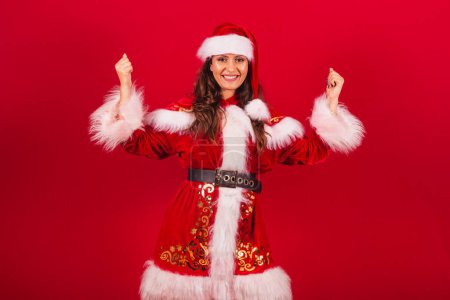Photo for Brazilian woman dressed in Christmas clothes, Santa Claus. celebrating. - Royalty Free Image