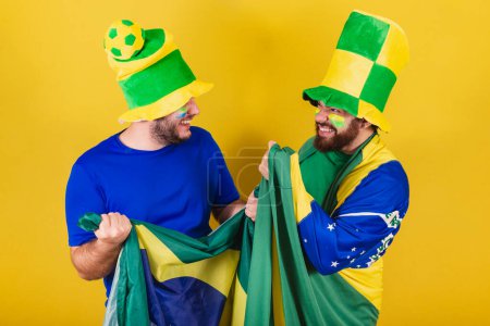 Photo for Two friends, Brazilians, soccer fans from Brazil, dressed to cheer in a championship. - Royalty Free Image