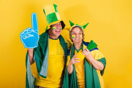 Téléchargez les photos : Couple adulte, fan de football brésilien, drapeau et chapeau. vibrant, wow, incroyable. - en image libre de droit