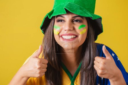 Photo for Close-up photo, Woman supporter of Brazil, world cup 2022, positive, affirmative, approval. wearing cheerleading outfit, flag and hat. - Royalty Free Image