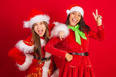 Photo for Two brazilian friends, dressed in christmas clothes, santa claus.. - Royalty Free Image